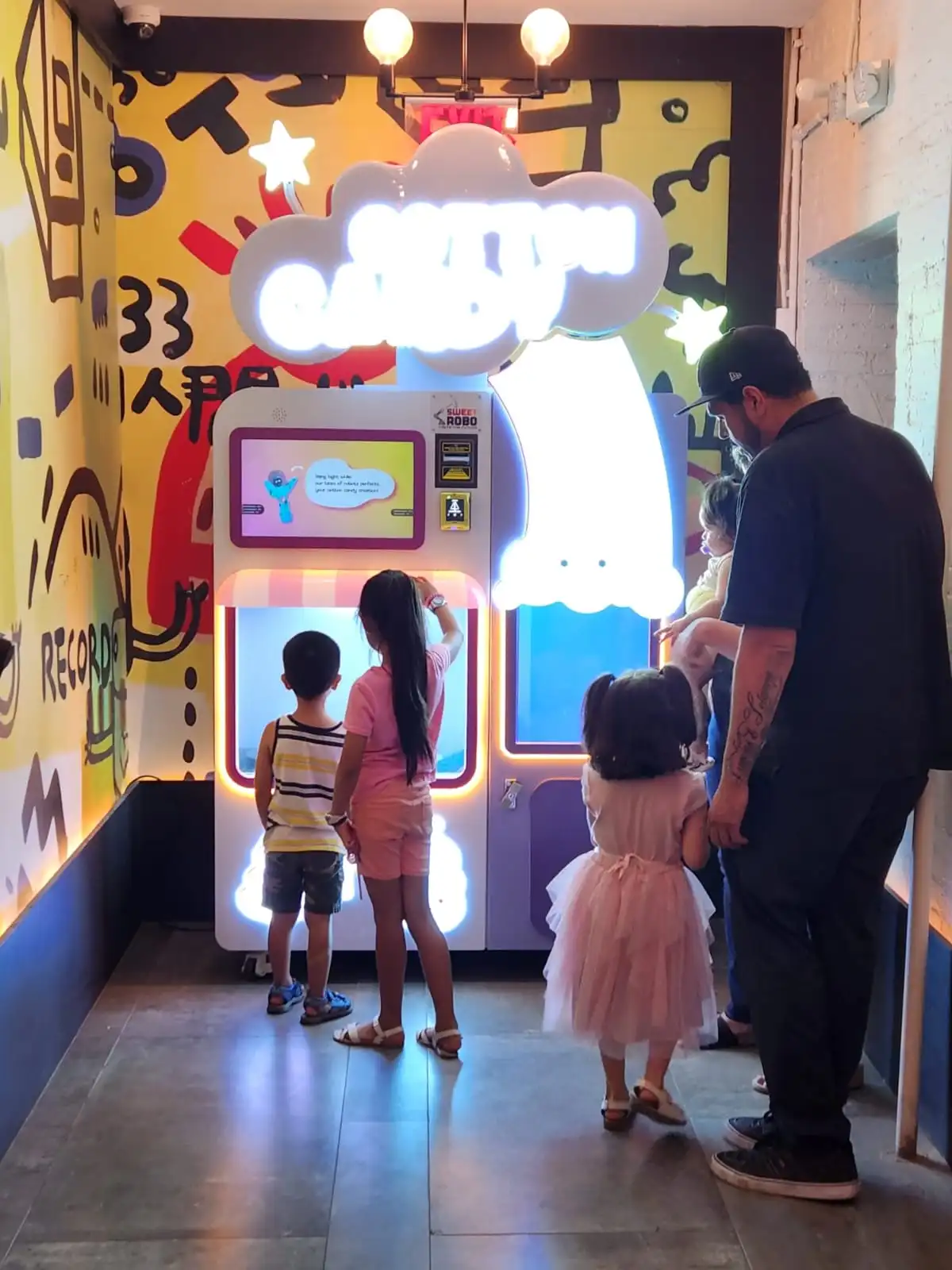 Family watching the Cotton Candy Robot create a treat