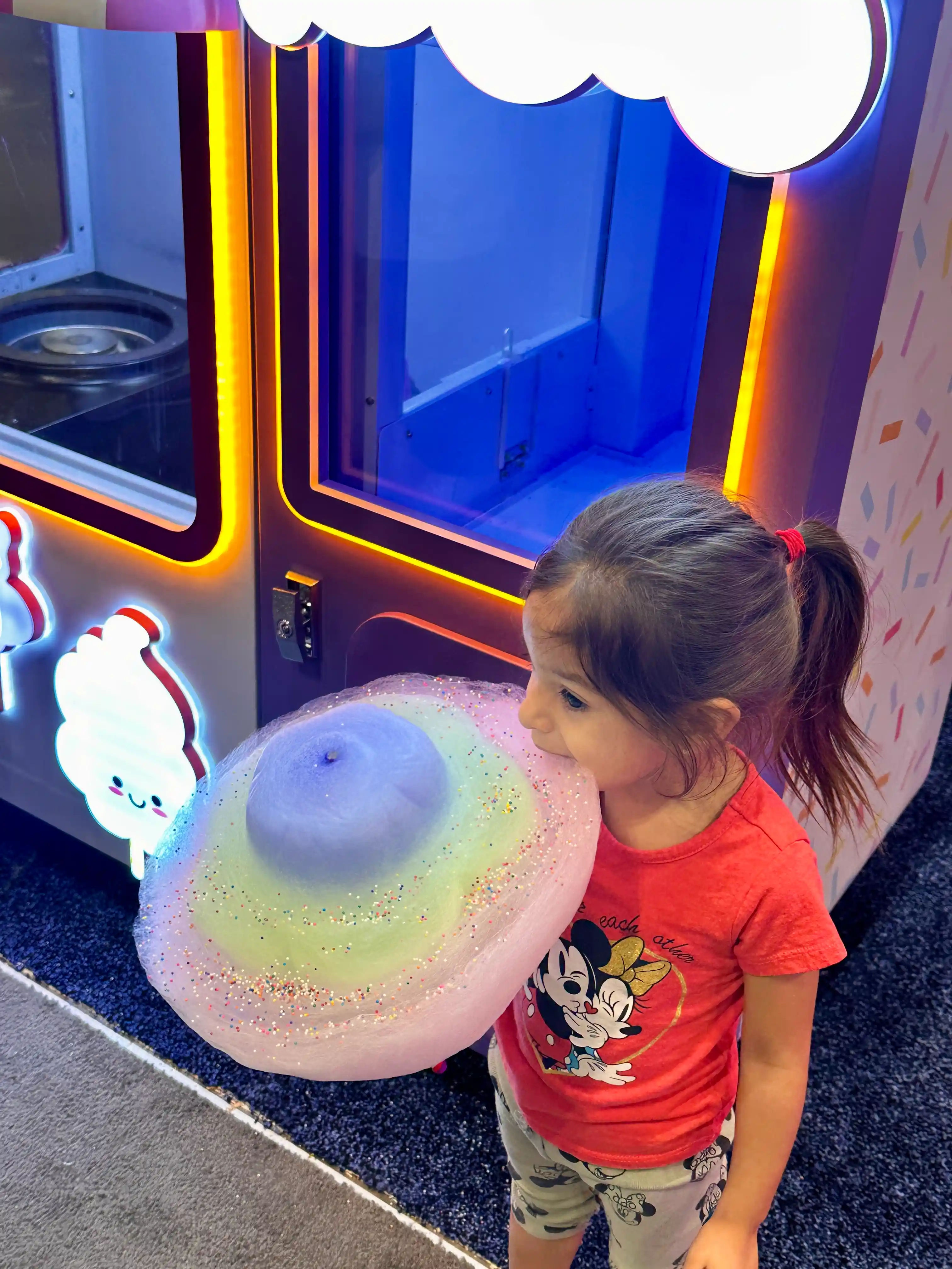 Child excited by a fresh cotton candy creation