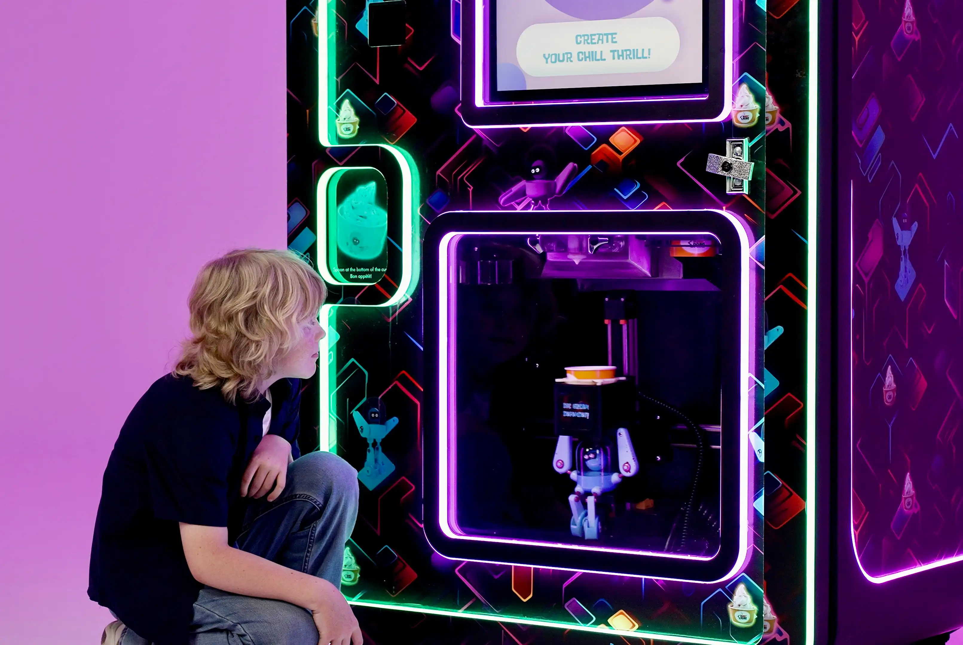 Child watching the Robo Ice Cream robot arm in action